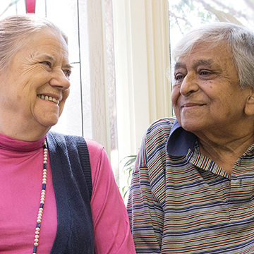 Pauline and Dipak Mazumdar smile fondly at each other